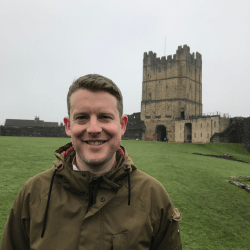 Professor Jamie Wood in front of a castle